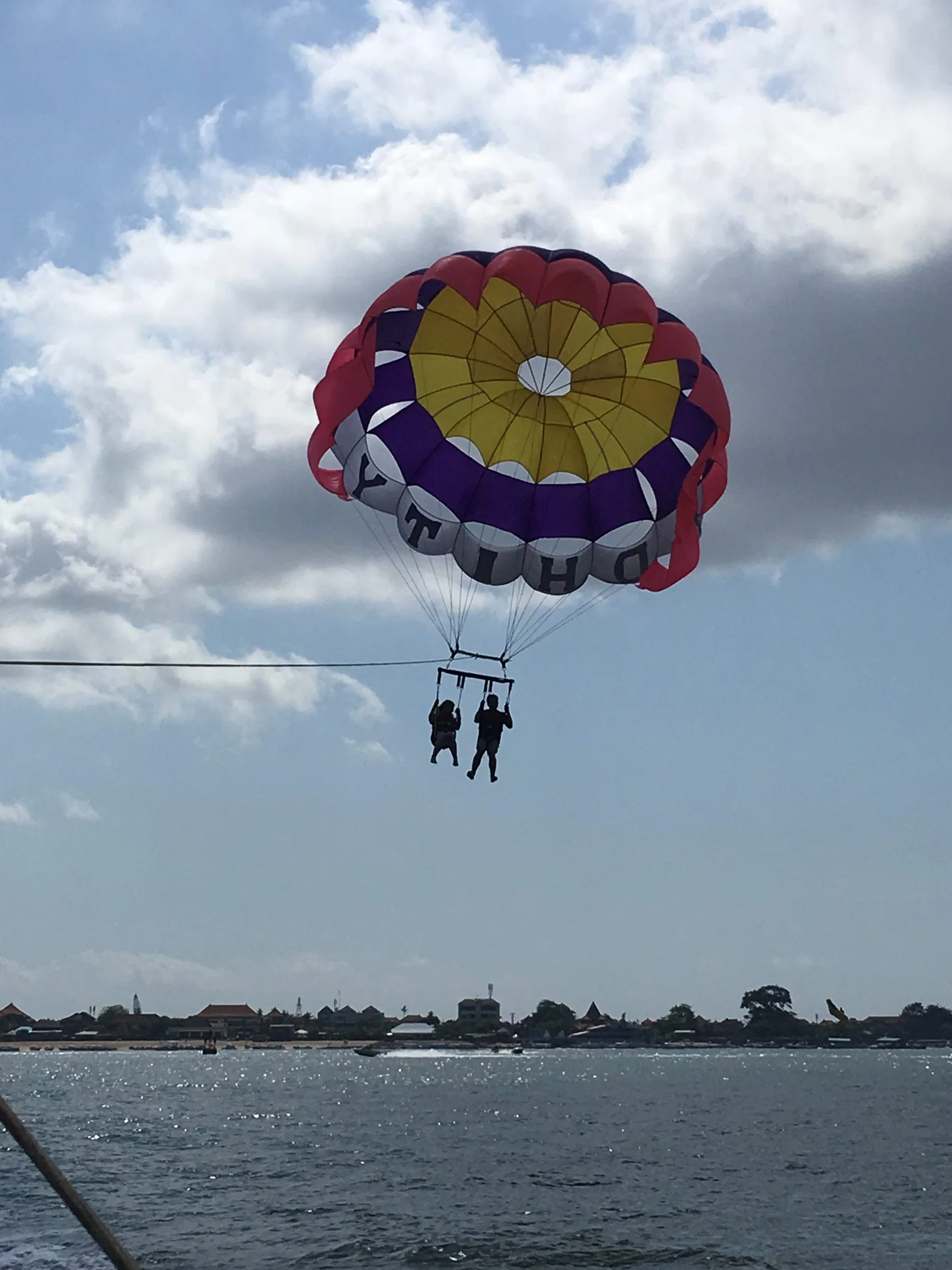 A parasail high above the bay at Tanjung Benoa
