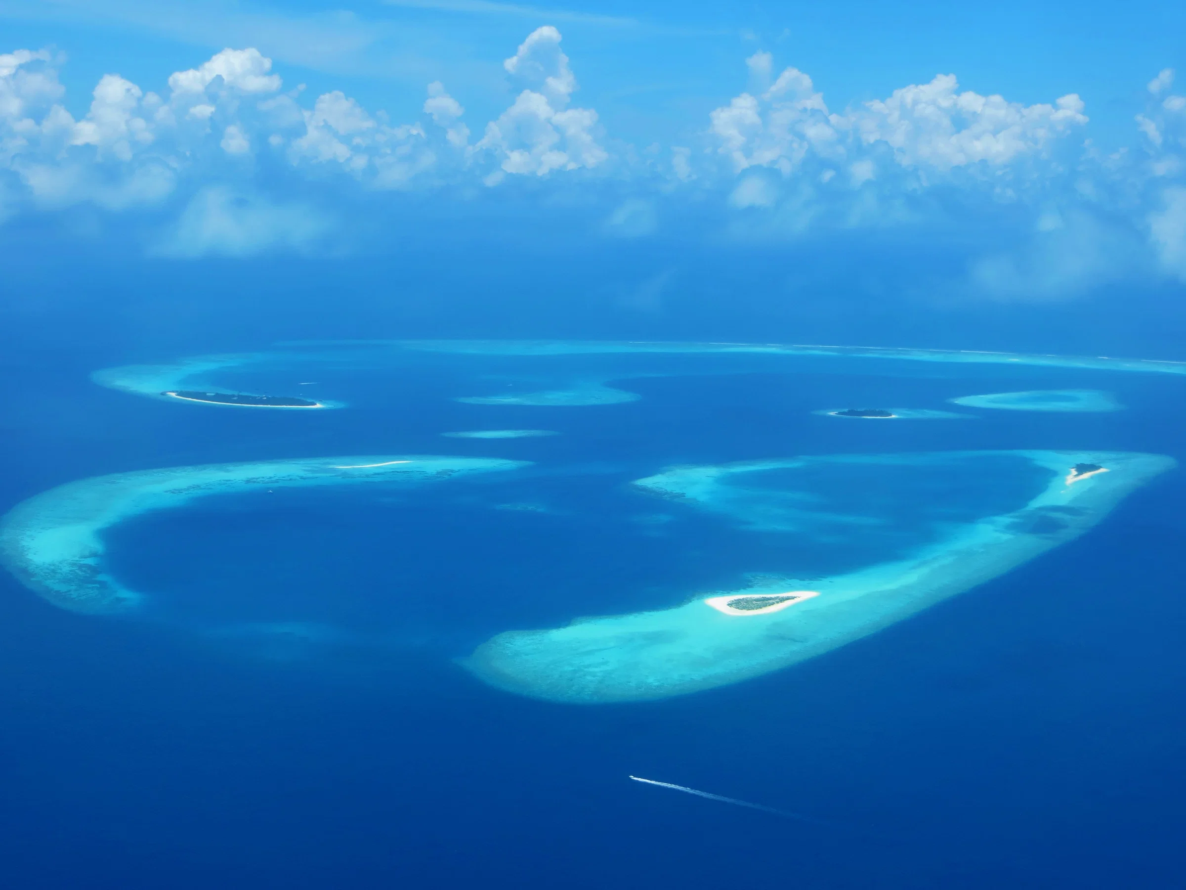 Aerial view of reef islands and turquoise lagoons in Baa Atoll
