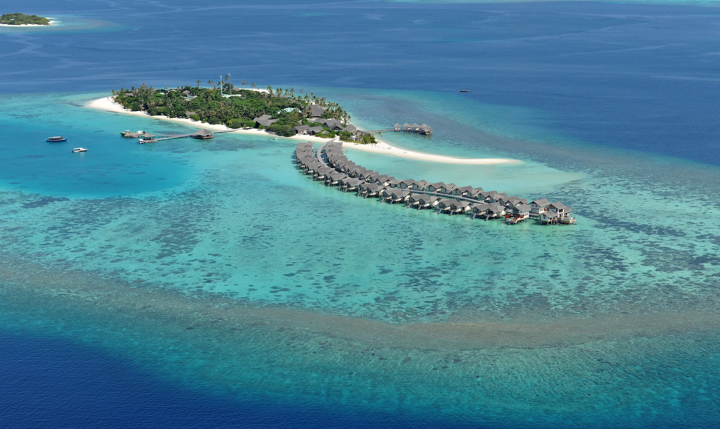 Aerial view of Maamigili island and its overwater villas, Raa Atoll