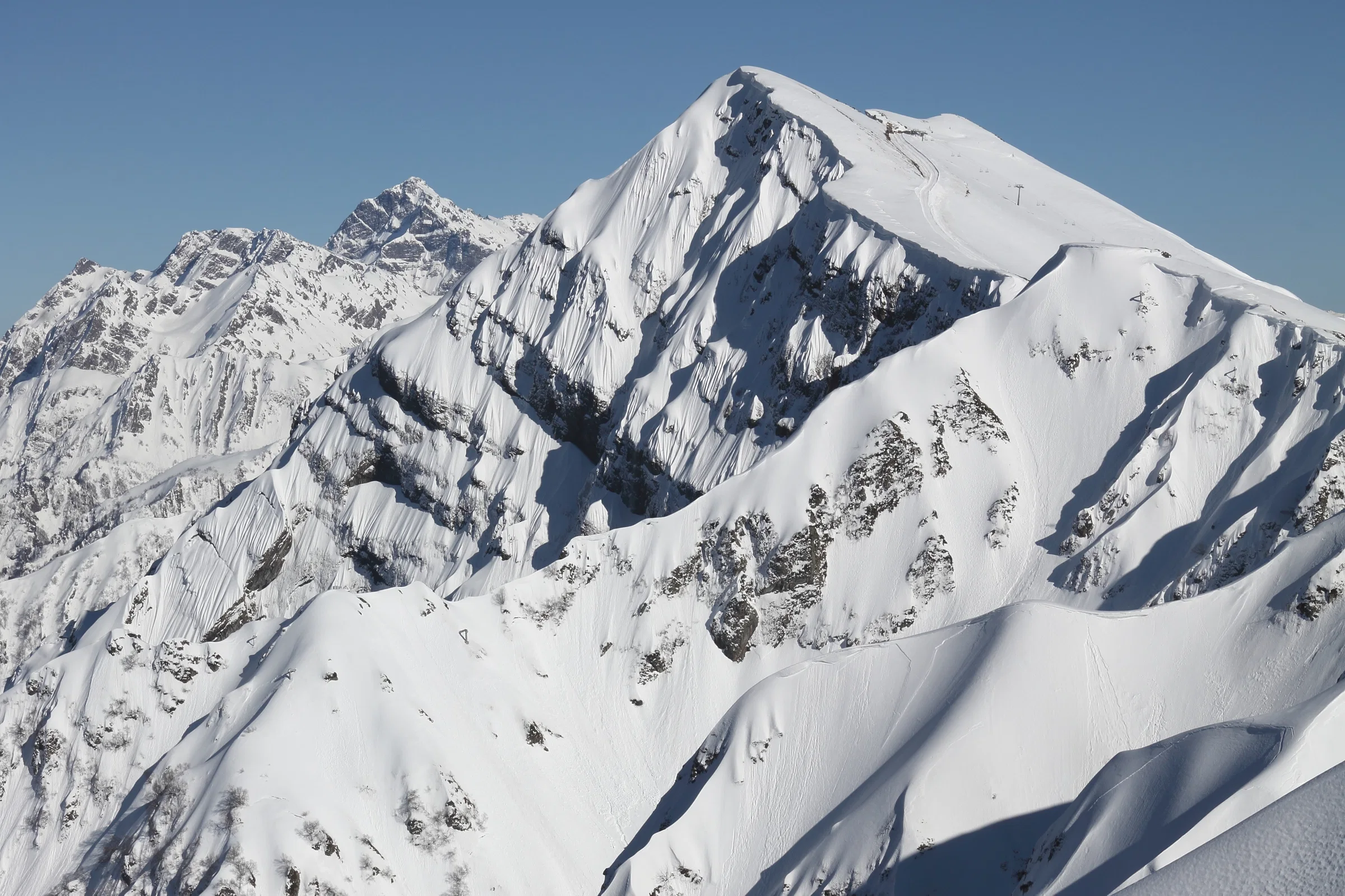 Snow-covered Caucasus peaks above Krasnaya Polyana, seen from the top lift station of Rosa Khutor