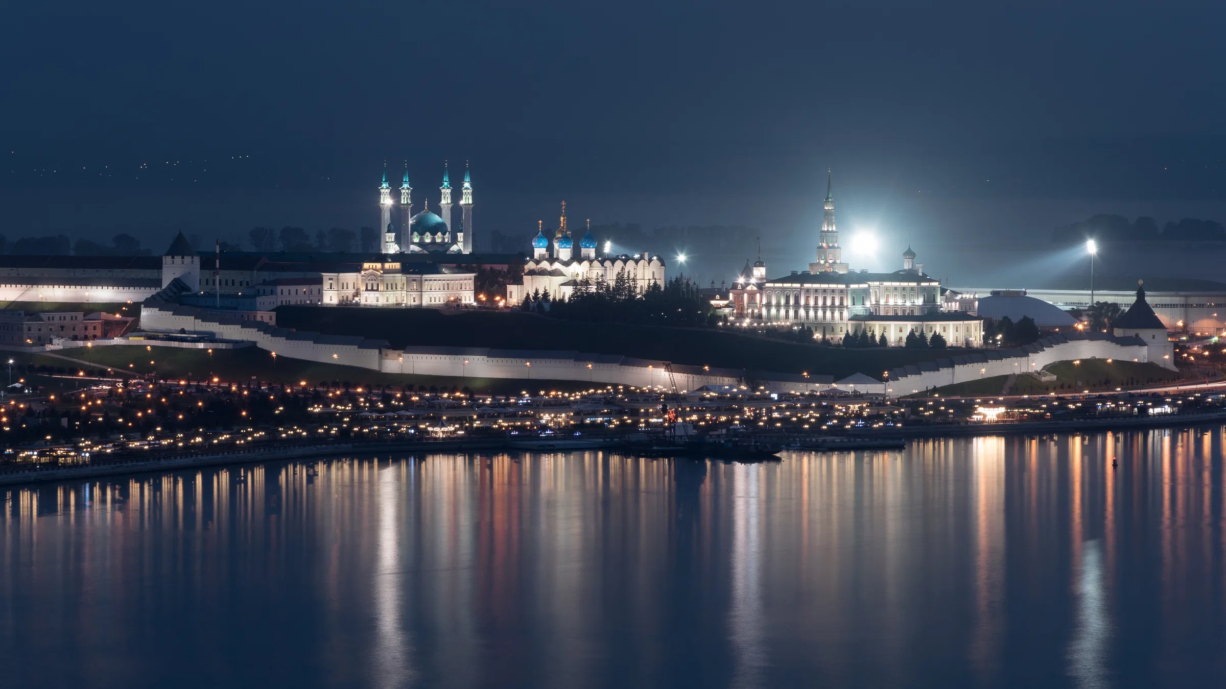 The Kazan Kremlin and the Kul Sharif Mosque lit in the evening above the river