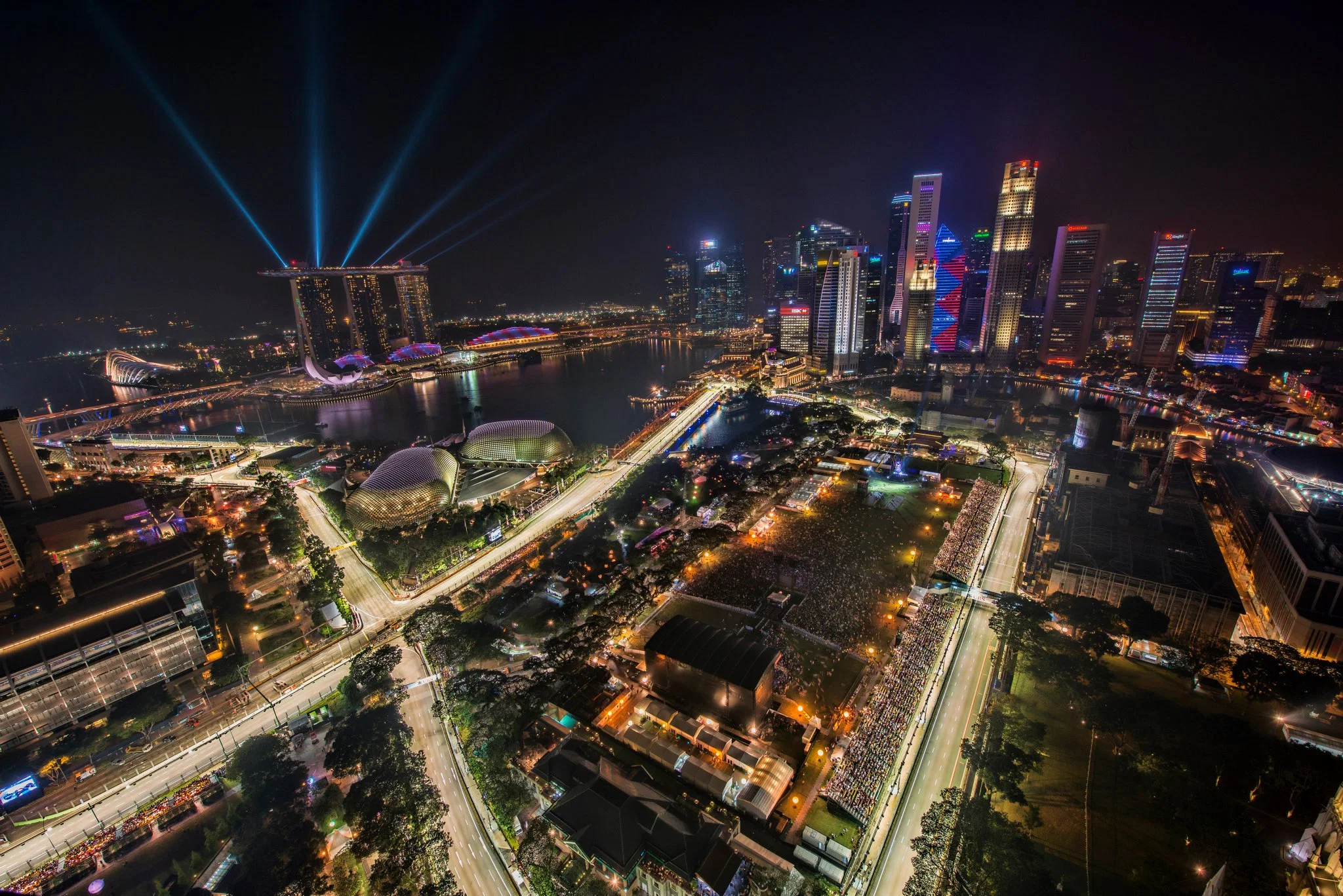 The floodlit Marina Bay Street Circuit during the 2012 Singapore Grand Prix night race, seen from above with the city skyline