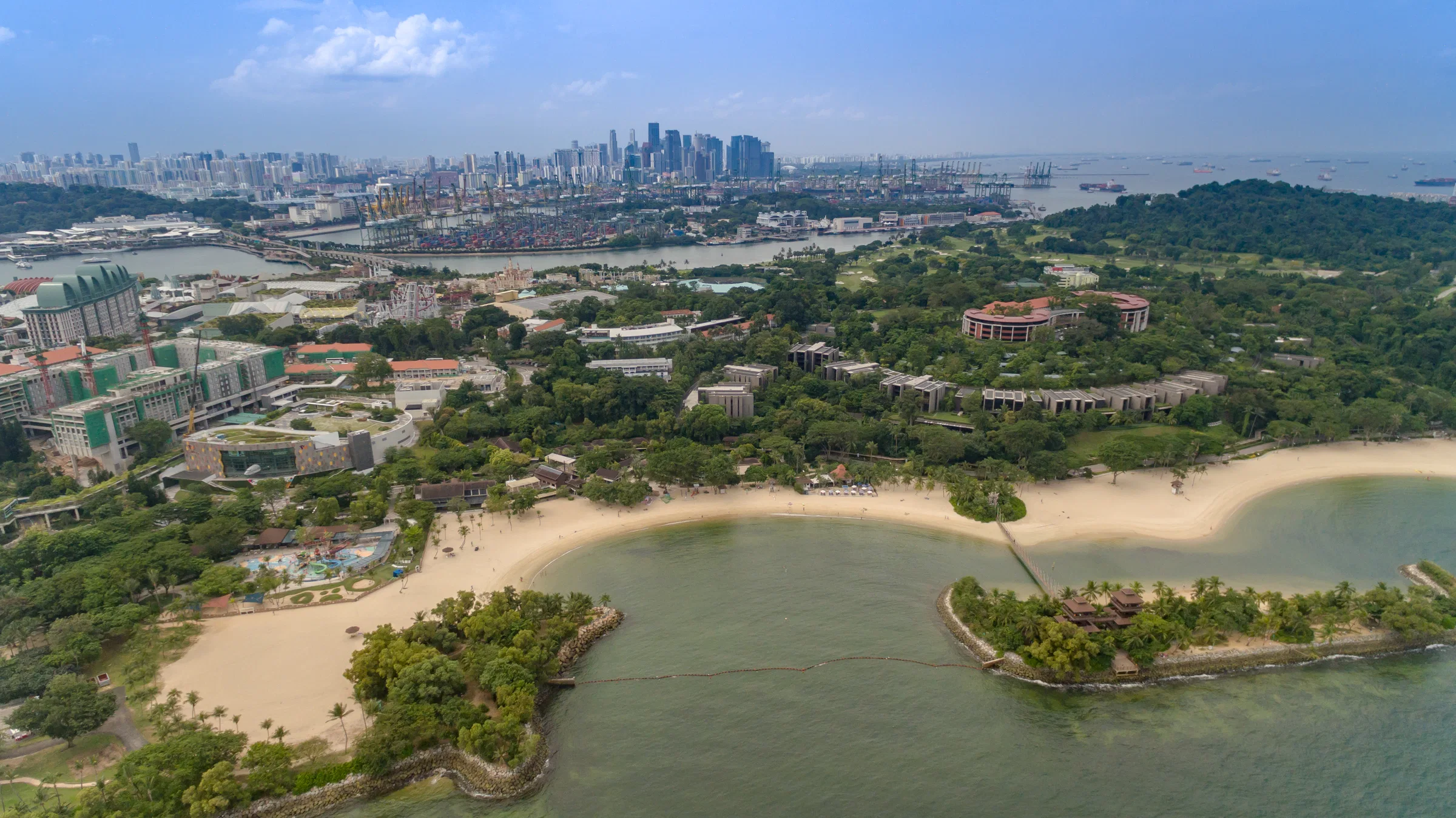 Aerial view of Palawan Beach on Sentosa, with its small islet and the Singapore skyline on the horizon