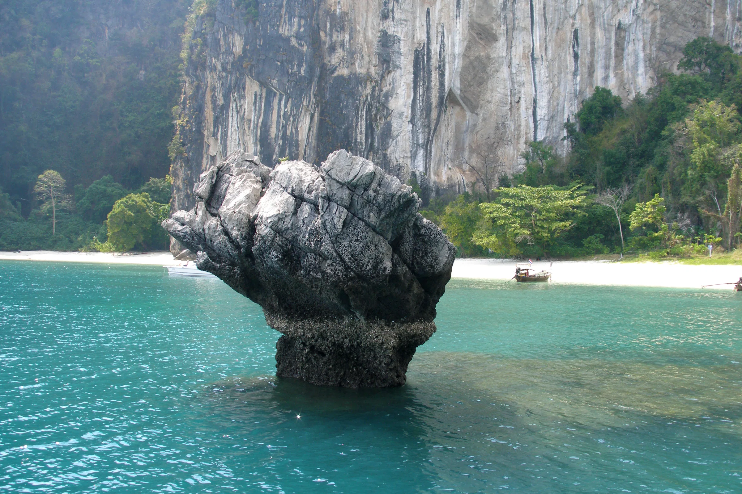 Turquoise lagoon, limestone cliffs and a balanced rock in Ao Phang Nga National Park