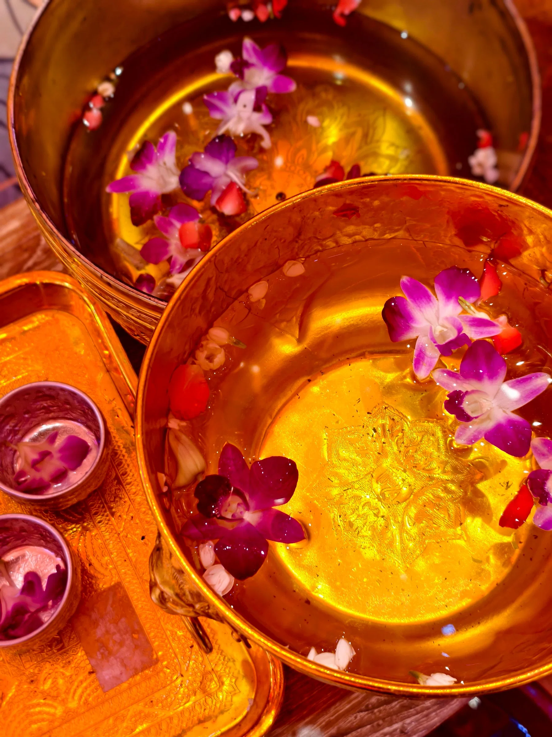 Orchids floating in golden bowls at a spa in Bangkok