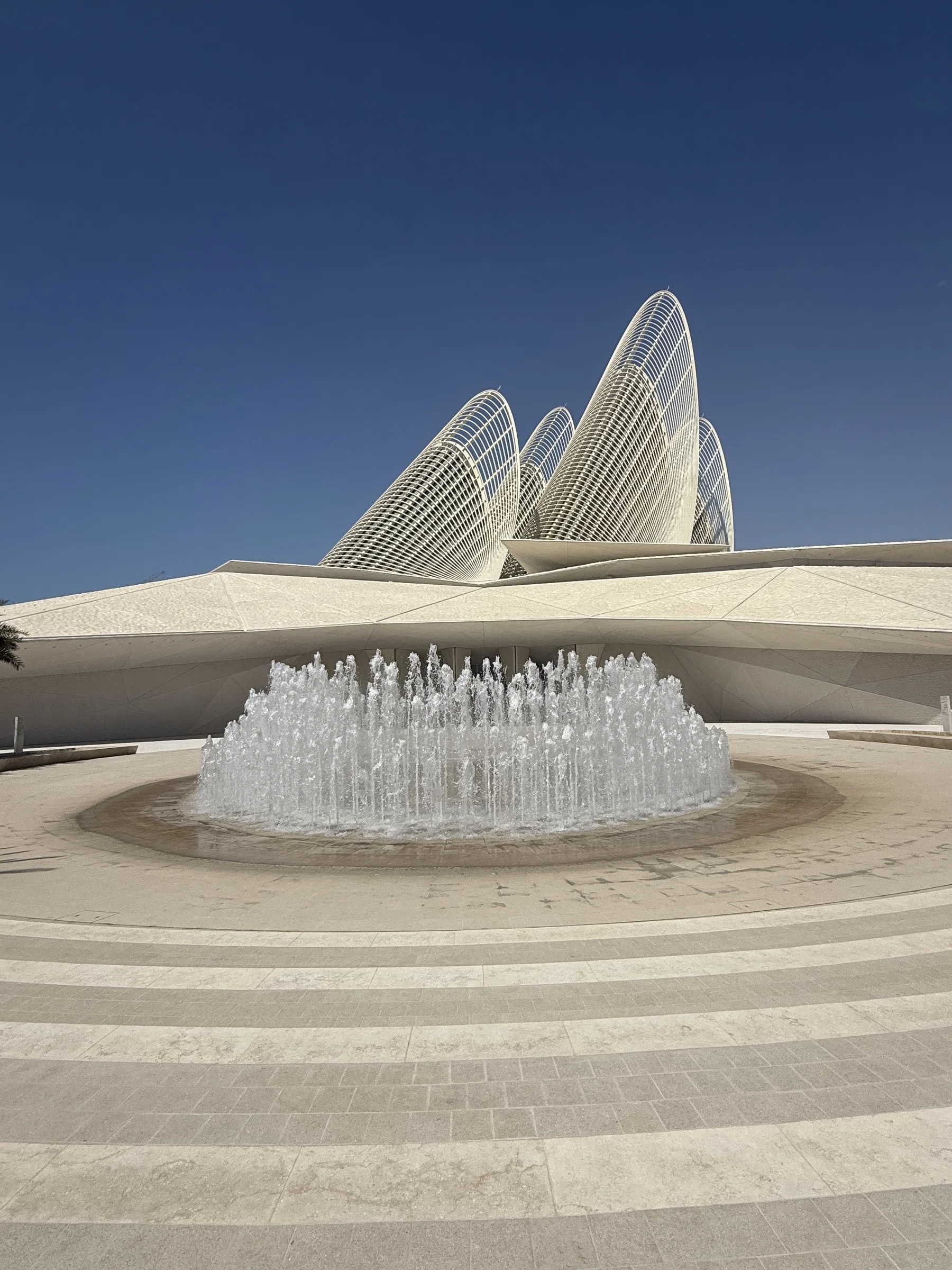 The front entrance of the Zayed National Museum, its steel wings above a fountain, Saadiyat Island