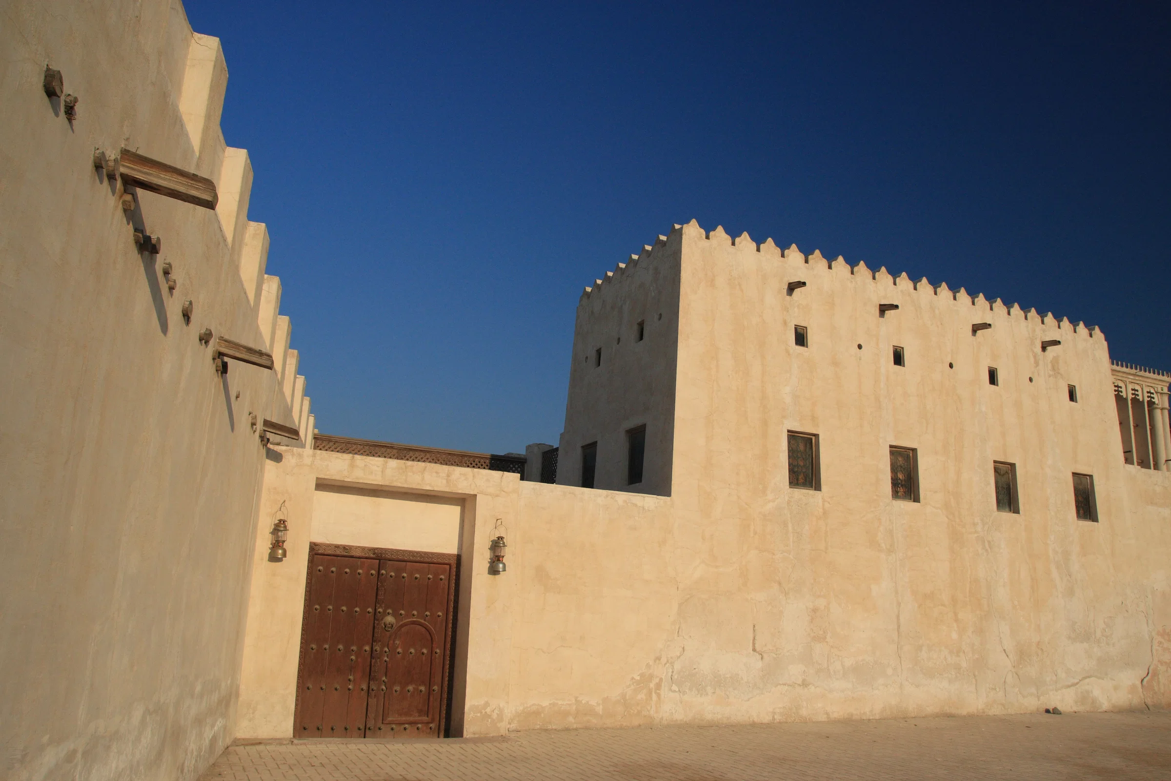 Restored coral-stone houses with wooden doors in the Sharjah Heritage Area