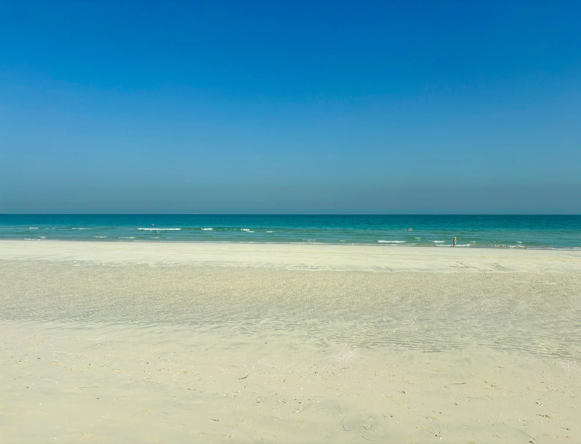 An empty white beach and calm sea in the early morning on Saadiyat Island
