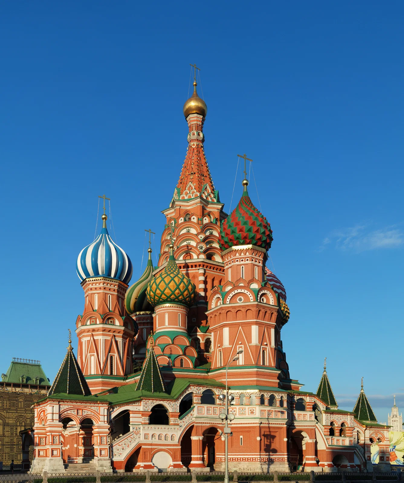 The Moscow Kremlin at night, its walls and towers lit above the Moskva River embankment
