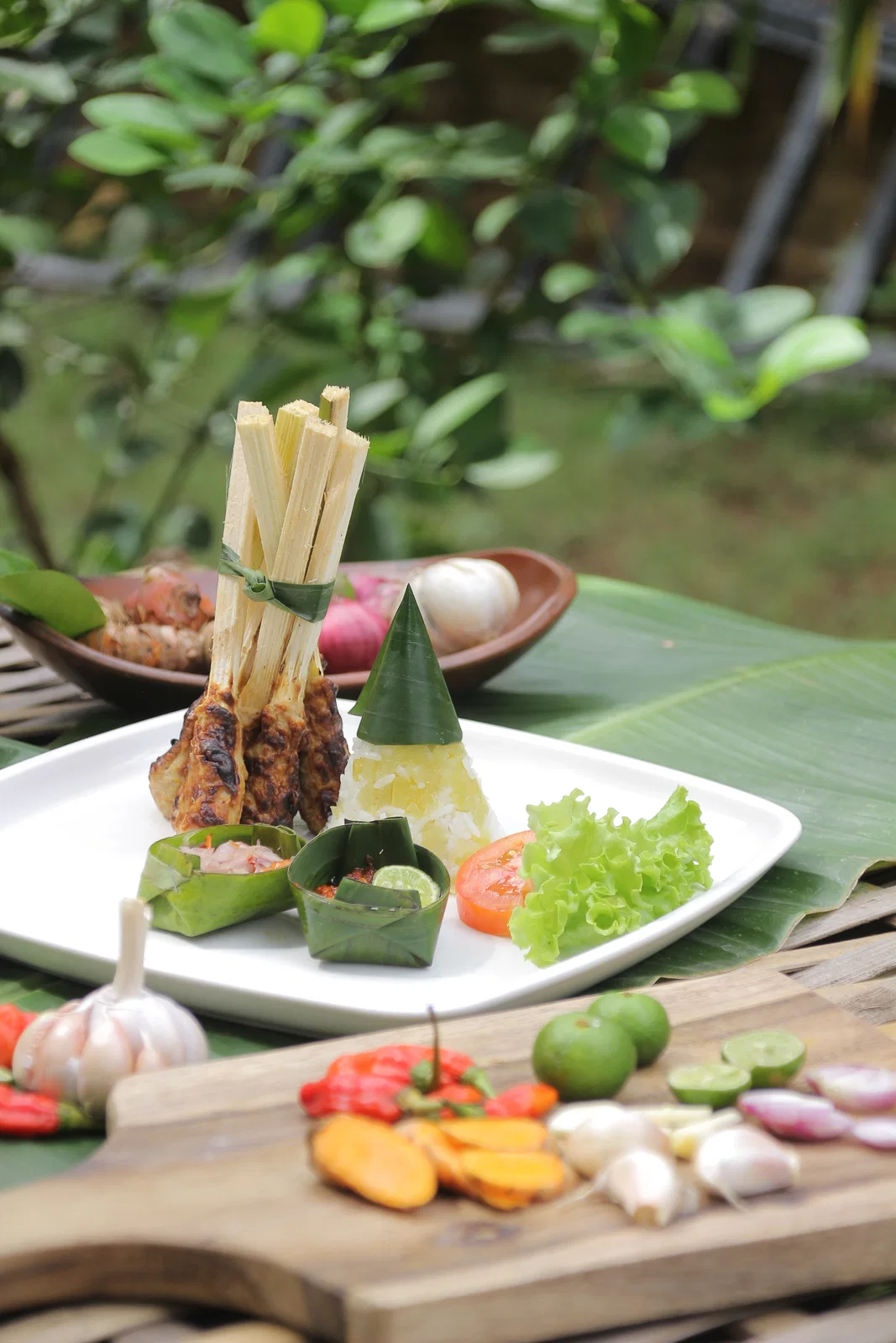 Sate lilit on lemongrass sticks served Balinese style with rice and sambal