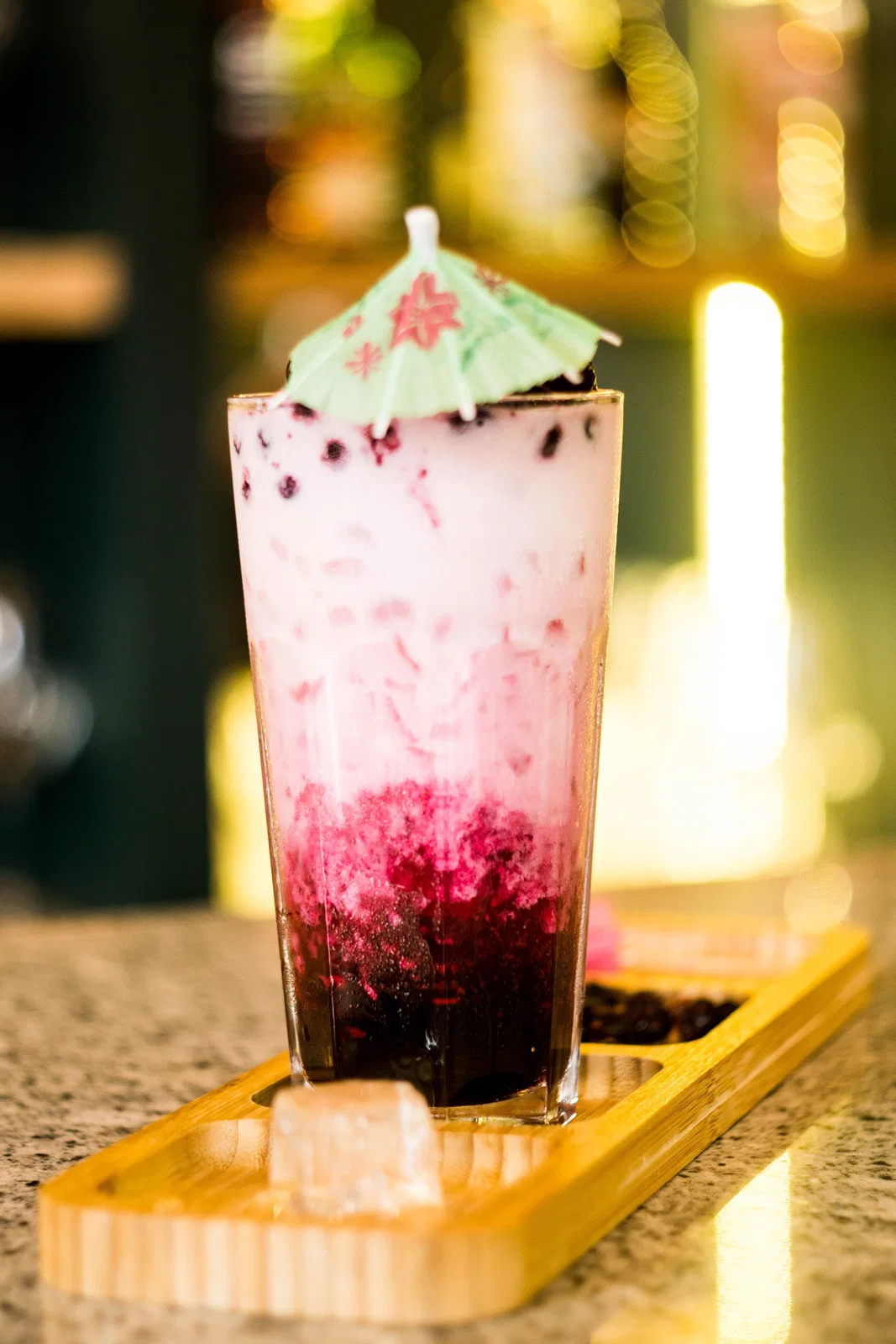 A chilled, layered milk drink in a tall glass, similar to Mauritian alouda