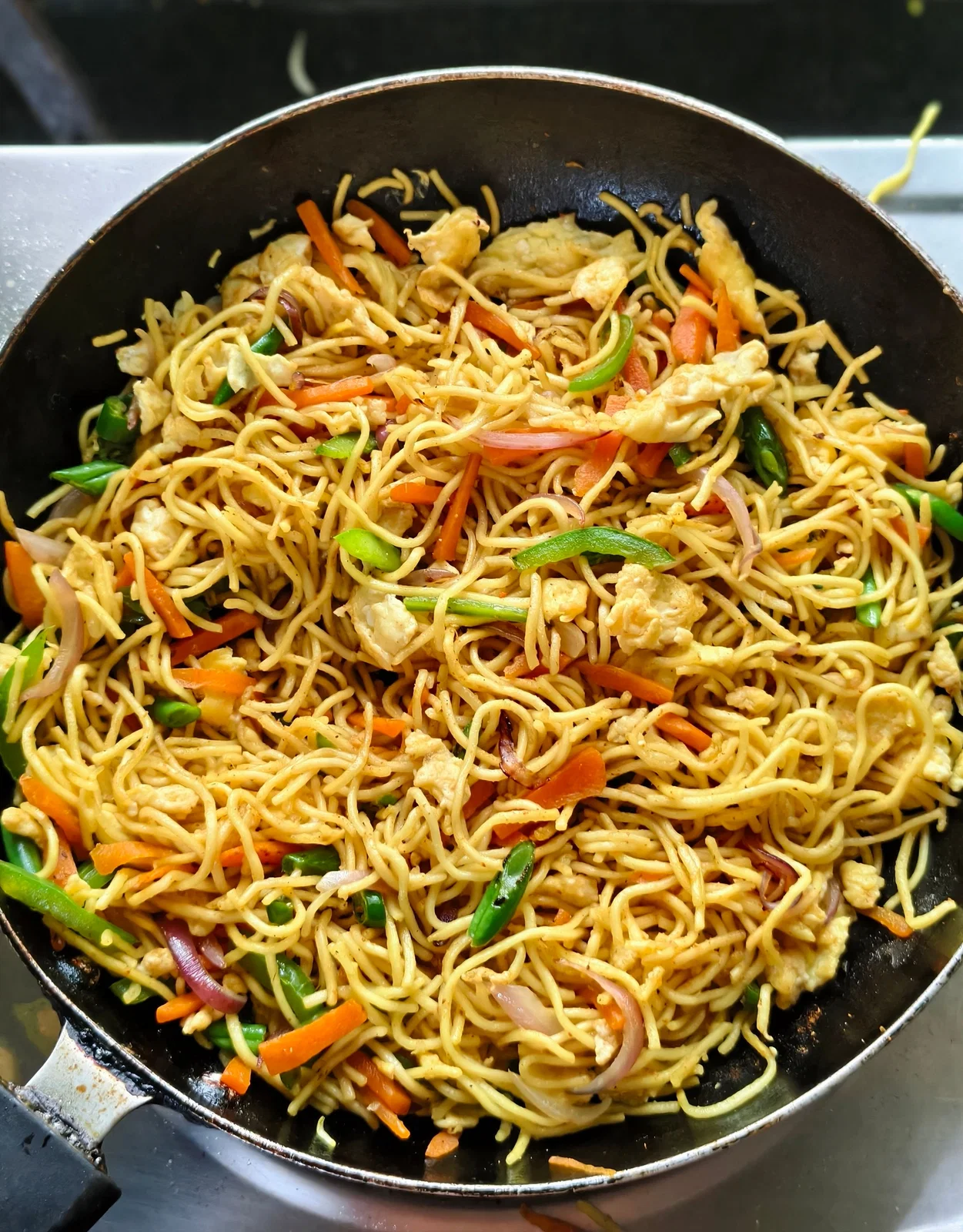 Stir-fried noodles with vegetables in a wok