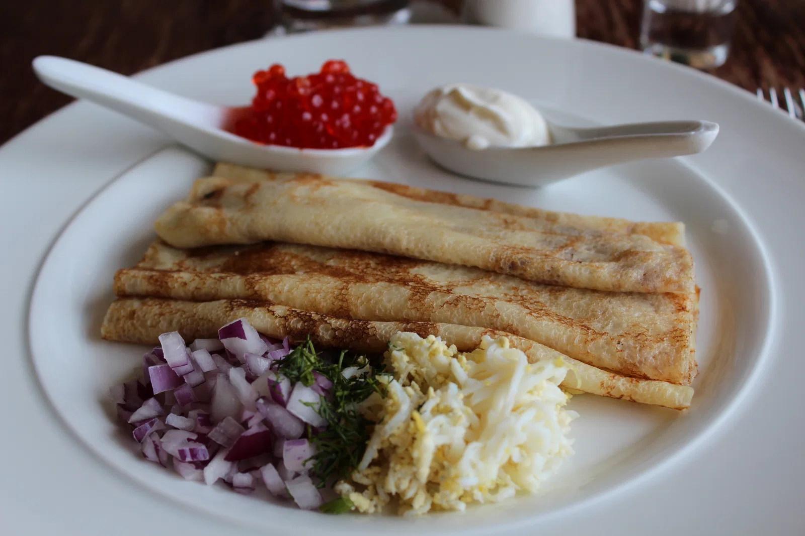 Blini with sour cream, red caviar and chopped onion at Singer Café, Saint Petersburg