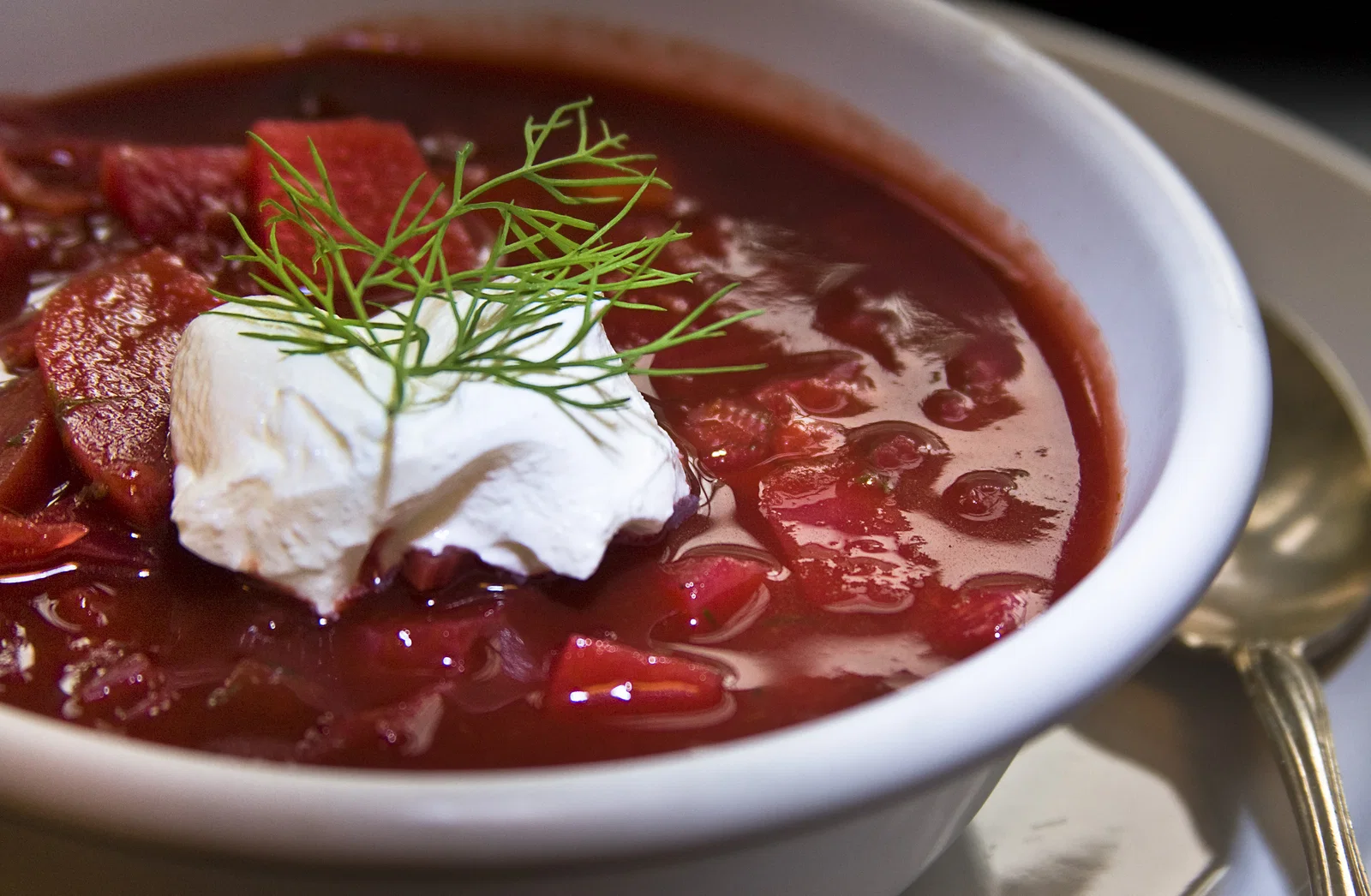 A bowl of beetroot borscht with sour cream and dill
