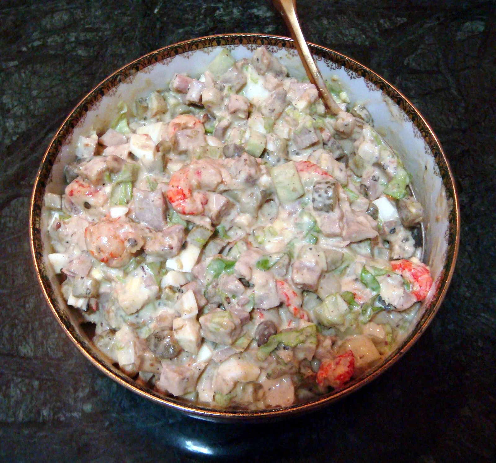 Olivier salad made to the original Hermitage restaurant recipe, in a gilt-rimmed bowl