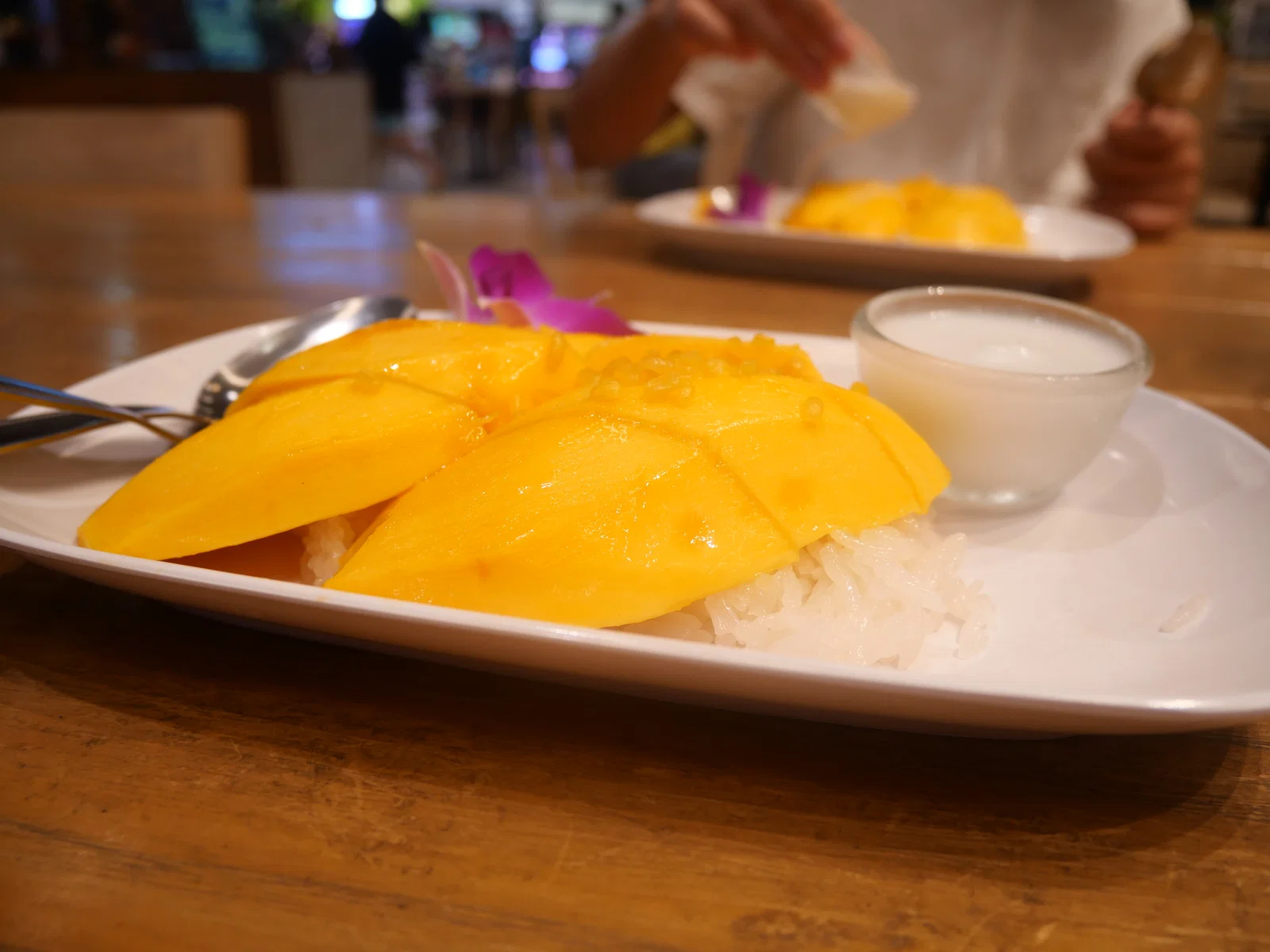 Mango sticky rice with coconut milk, served in Thailand