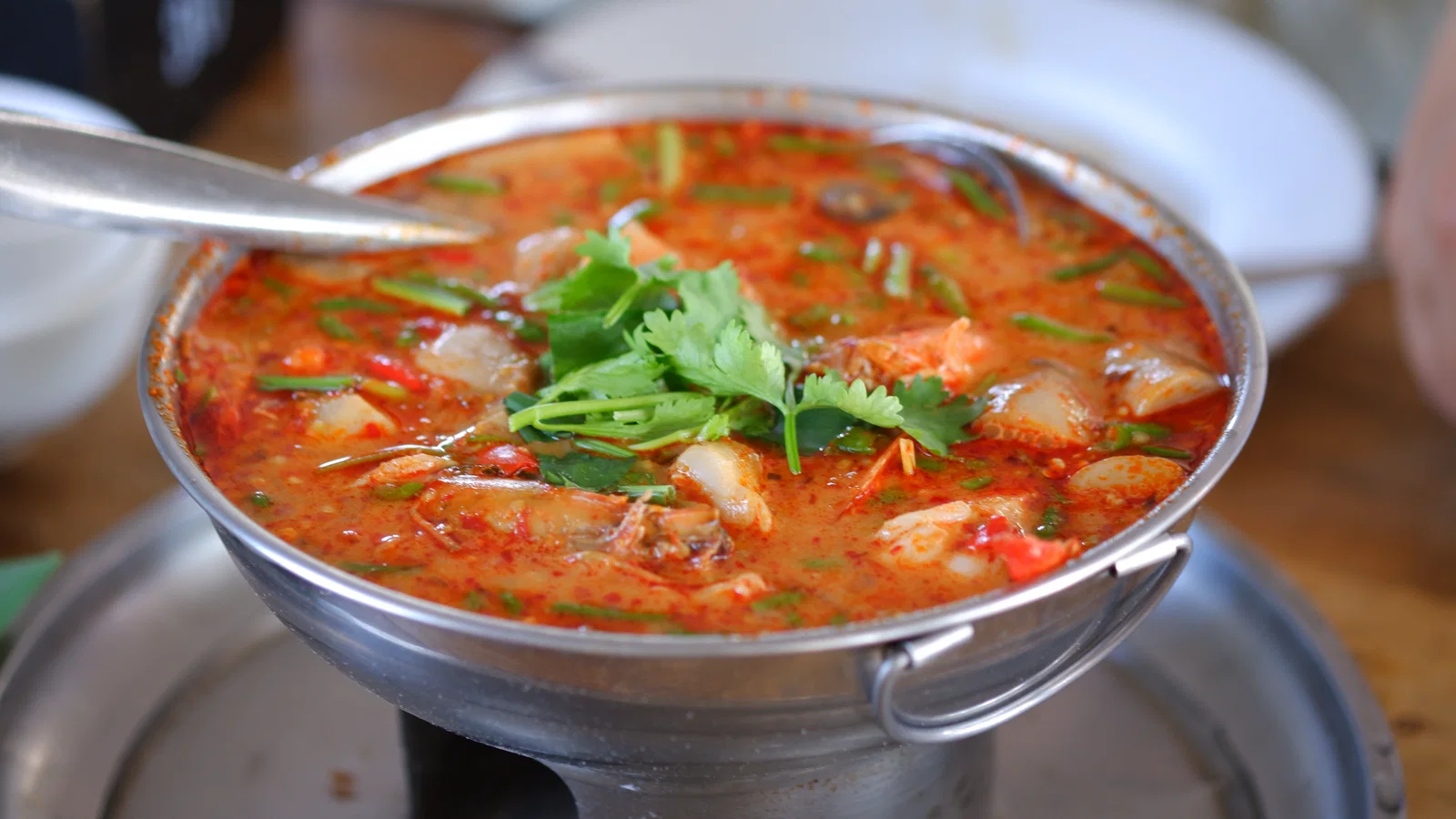 Tom yam kung, hot and sour prawn soup, in a serving pot