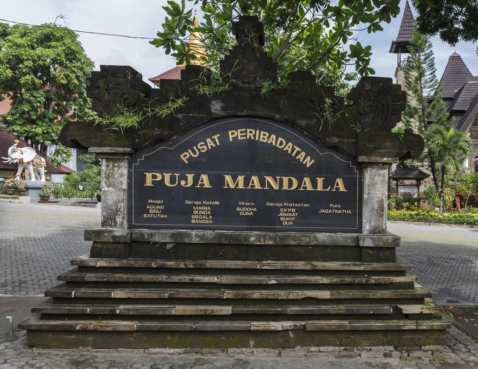 The carved stone sign at the entrance of the Puja Mandala complex of five houses of worship near Nusa Dua
