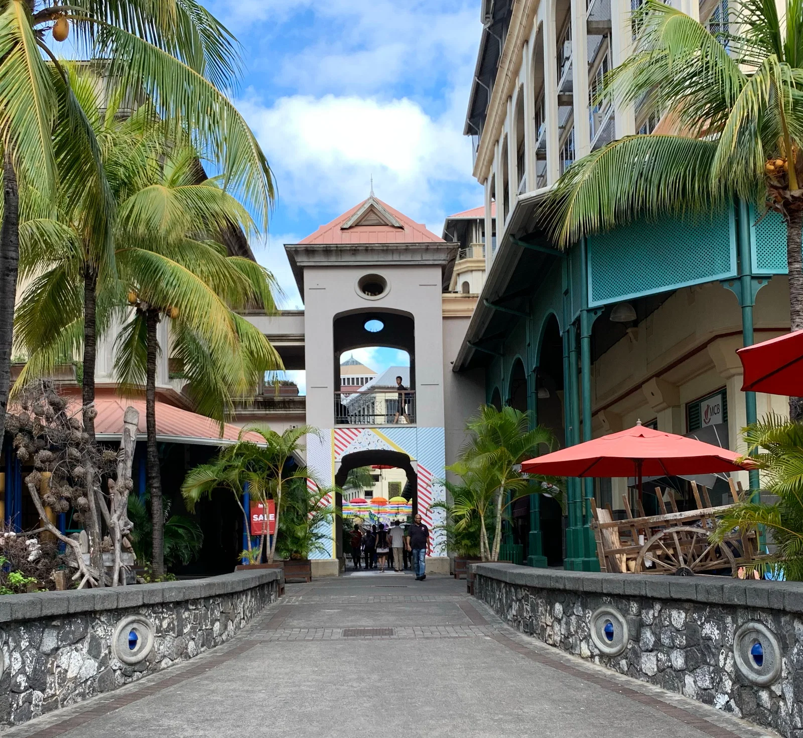 A palm-lined walkway at Le Caudan Waterfront, Port Louis