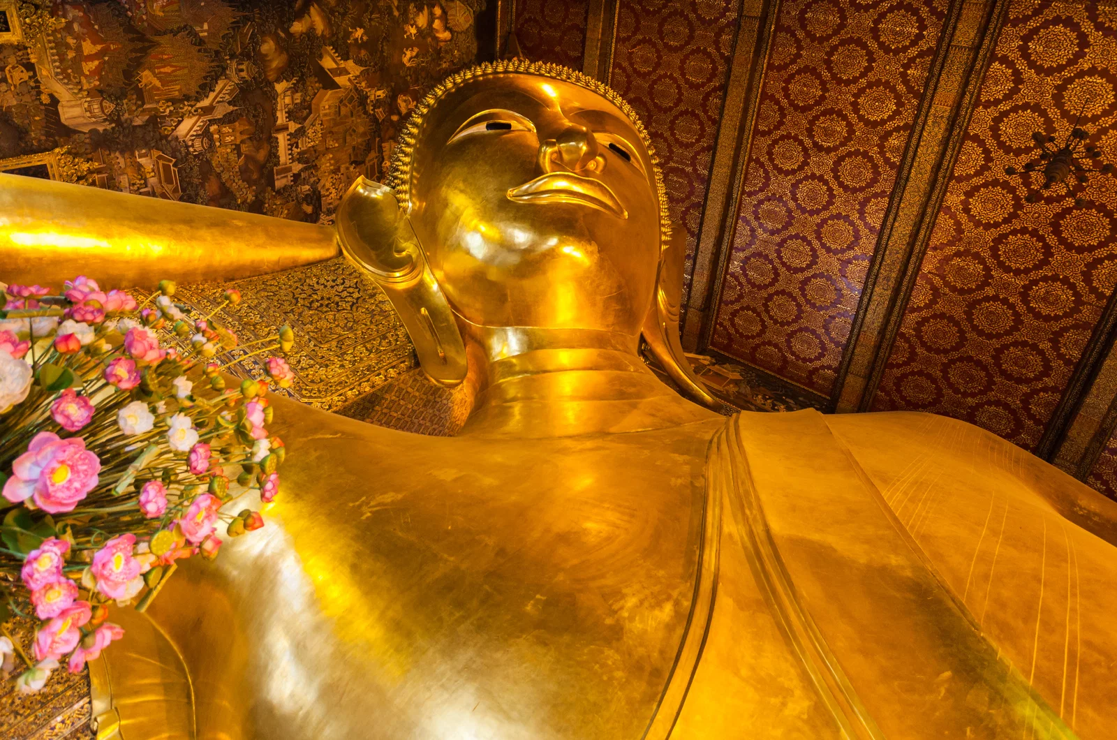 The gilded head of the Reclining Buddha at Wat Pho, Bangkok