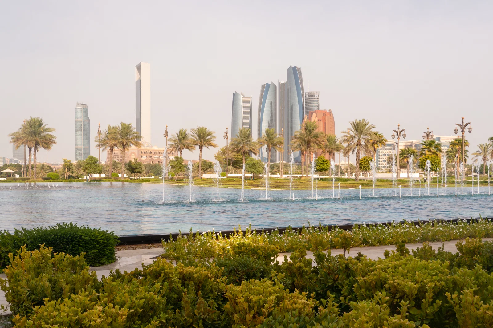 Fountains in the gardens of Qasr Al Watan with the Abu Dhabi skyline beyond